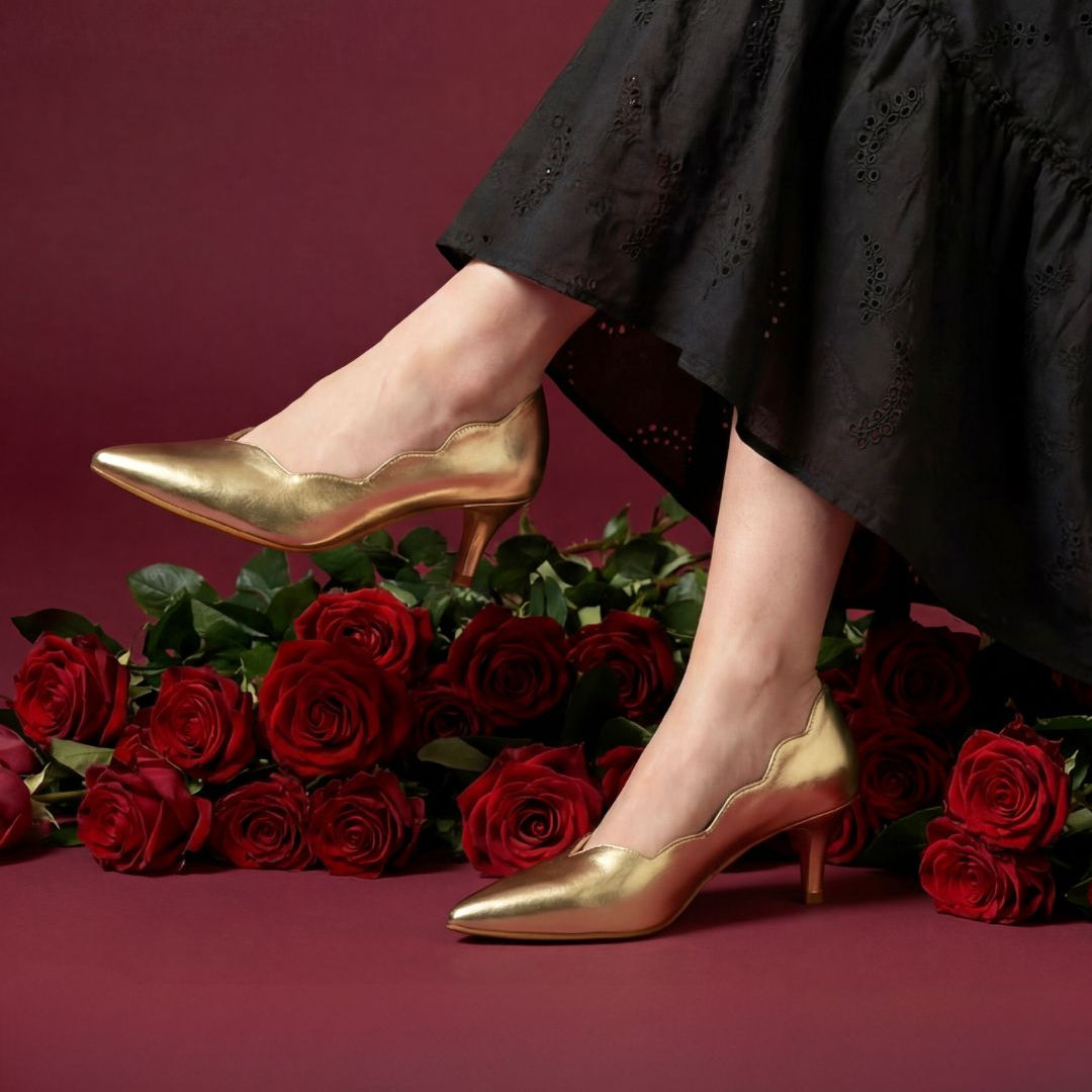 Gold high heels on a red background with red roses